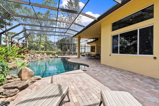 pool featuring a patio and glass enclosure