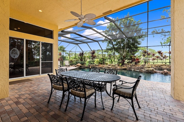 view of patio featuring a ceiling fan, a lanai, outdoor dining space, and an outdoor pool