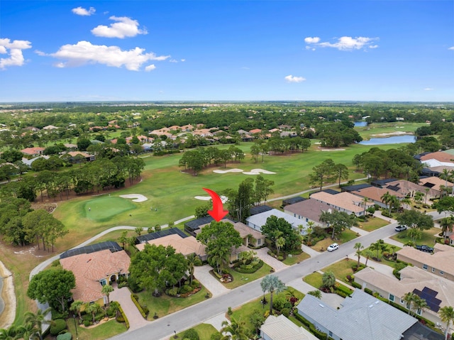 drone / aerial view featuring a residential view, a water view, and golf course view
