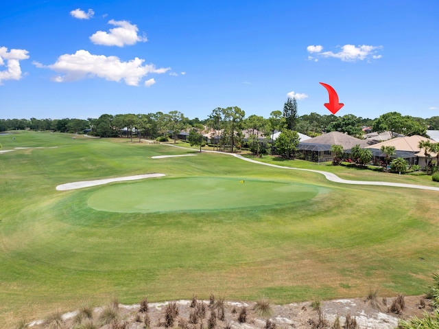 view of property's community with a residential view and view of golf course