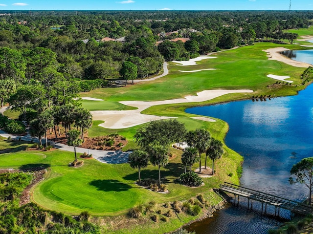 birds eye view of property with a water view and golf course view
