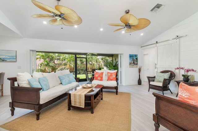 1155 Rainwood Cir, Palm Beach Gardens, FL 33410 - living area with a ceiling fan, high vaulted ceiling, visible vents, and a barn door