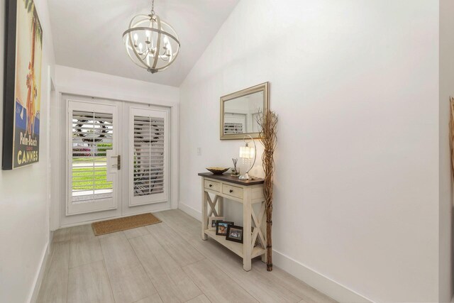 1155 Rainwood Cir, Palm Beach Gardens, FL 33410 - entrance foyer featuring baseboards, an inviting chandelier, french doors, and lofted ceiling