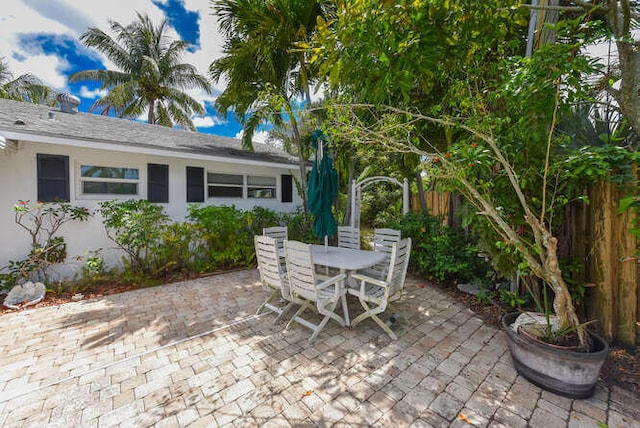 view of patio featuring fence and outdoor dining space