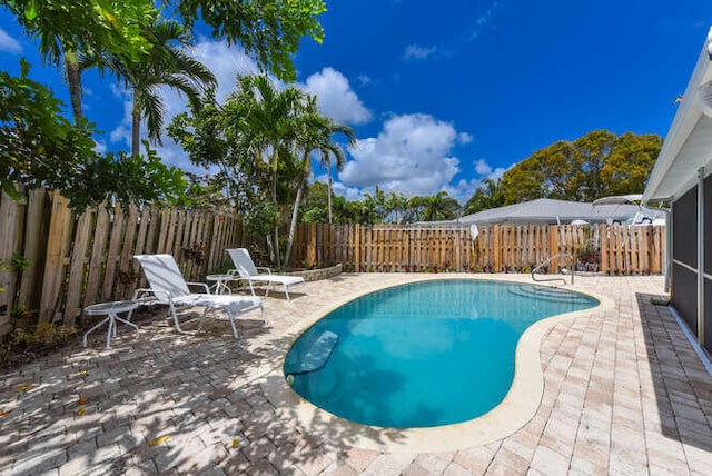 view of swimming pool featuring a patio, a fenced backyard, and a fenced in pool