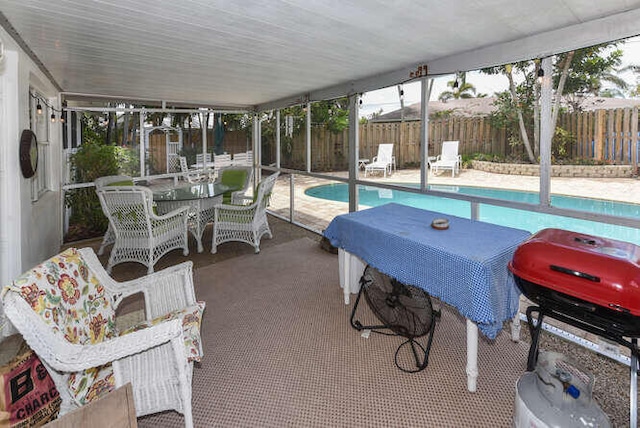sunroom featuring outdoor dining area