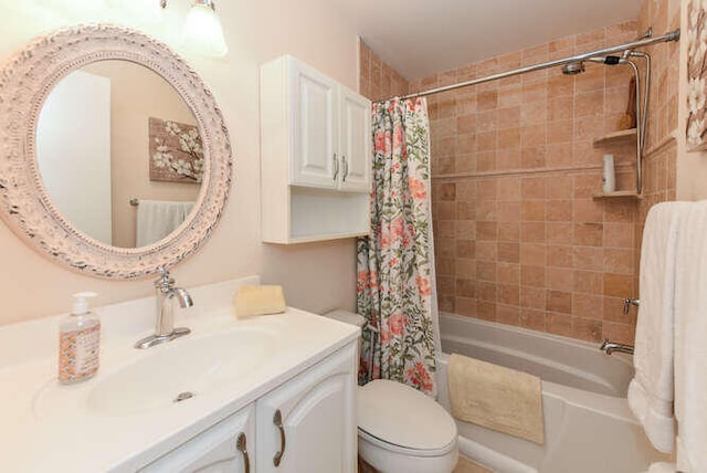 bathroom with toilet, shower / bath combo, and vanity
