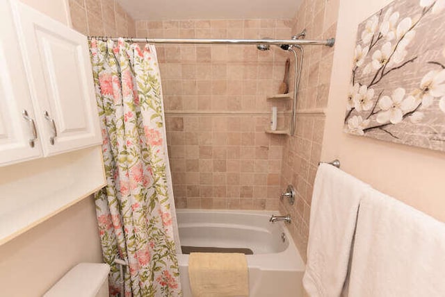 bathroom featuring toilet and shower / bath combo
