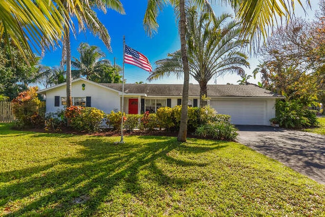 ranch-style home with a front lawn, driveway, and an attached garage