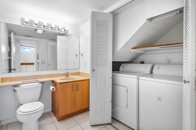 bathroom with vanity, toilet, tile patterned floors, washing machine and dryer, and a closet