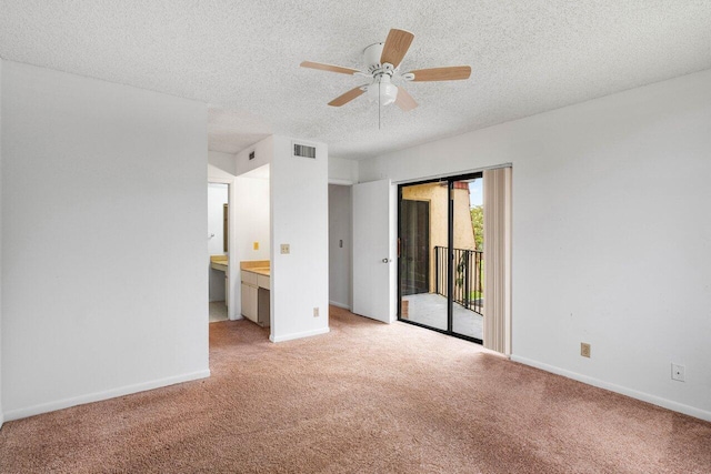unfurnished bedroom featuring access to outside, a textured ceiling, visible vents, and light carpet