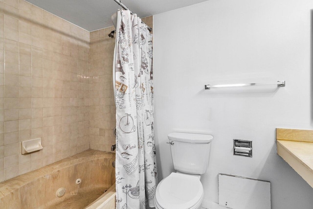 full bathroom featuring shower / bath combo with shower curtain and toilet