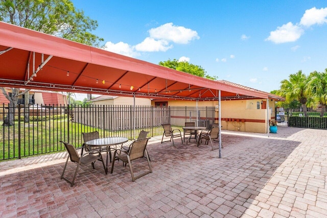 view of patio with fence and outdoor dining space