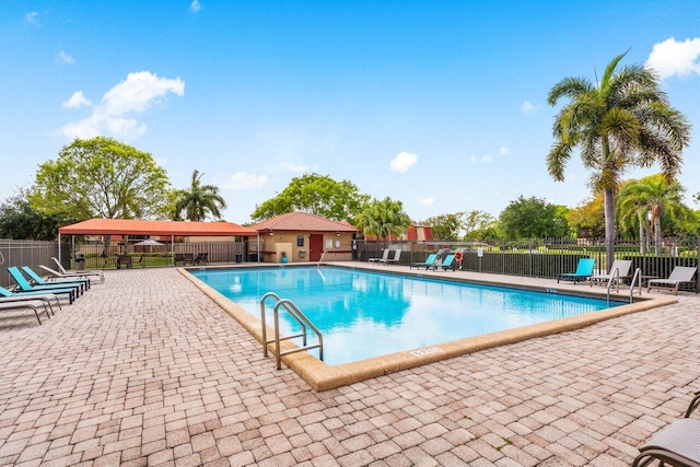 community pool featuring fence and a patio area