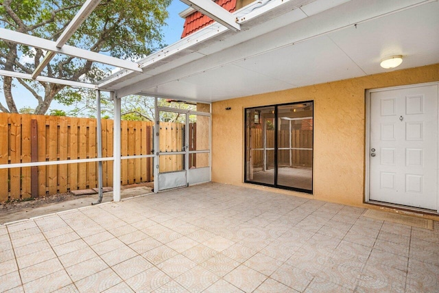 unfurnished sunroom featuring a skylight