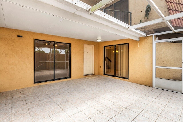 view of patio featuring glass enclosure