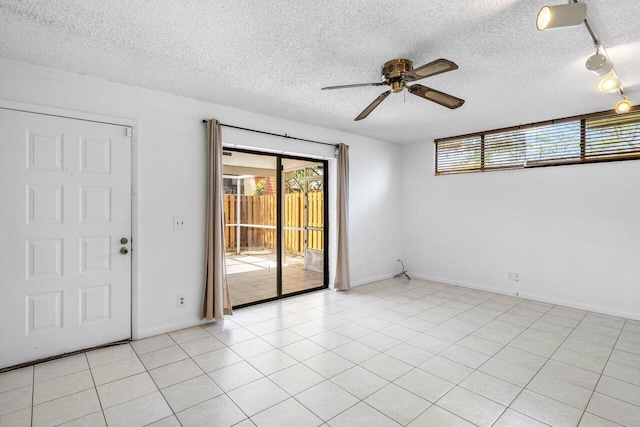 empty room featuring baseboards, a textured ceiling, and ceiling fan