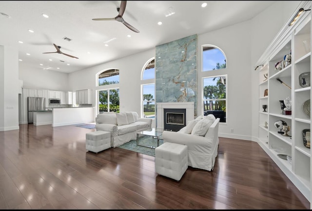 3950 Fieldview Way, Wellington, FL 33414 - living room with recessed lighting, a ceiling fan, a tile fireplace, and a towering ceiling