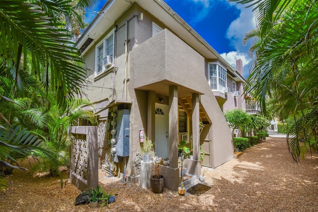 126 Peruvian Ave, Palm Beach, FL 33480 - view of front facade featuring stucco siding and cooling unit