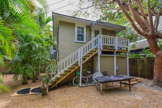 126 Peruvian Ave, Palm Beach, FL 33480 - rear view of house featuring stairway, fence, stucco siding, and a deck