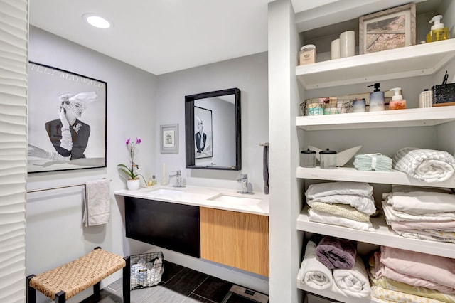 full bathroom featuring double vanity, wood finished floors, recessed lighting, and a sink