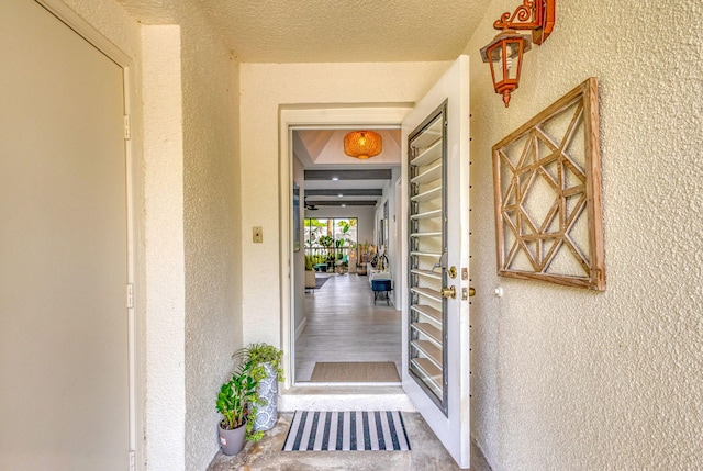 view of exterior entry featuring stucco siding