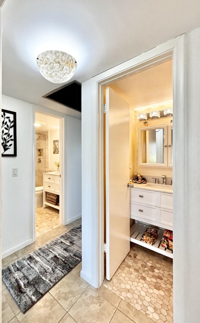 82 Camden Unit D, West Palm Beach, FL 33417 - hallway featuring light tile patterned floors and a sink