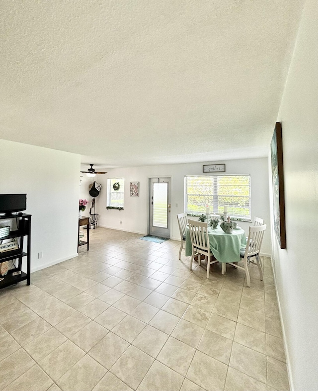 82 Camden Unit D, West Palm Beach, FL 33417 - dining room featuring light tile patterned flooring, a textured ceiling, baseboards, and a ceiling fan
