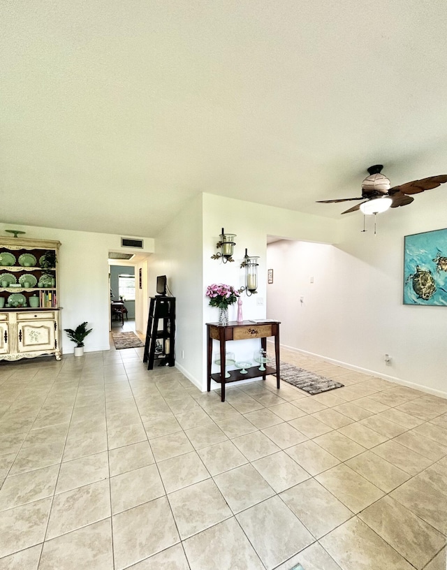82 Camden Unit D, West Palm Beach, FL 33417 - living room featuring light tile patterned floors, a ceiling fan, and baseboards