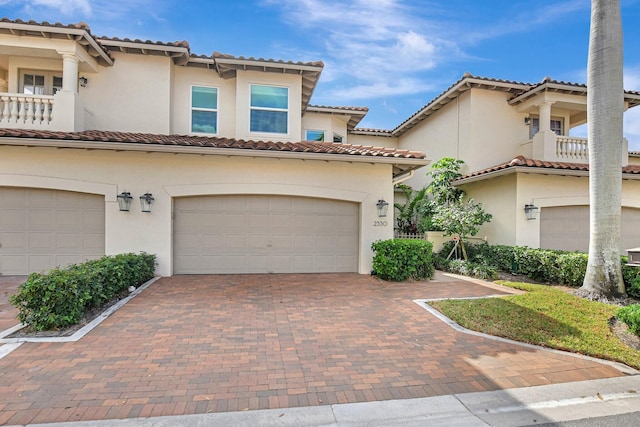 2530 NW 52nd St, Boca Raton, FL 33496 - mediterranean / spanish-style home with a tile roof, an attached garage, and decorative driveway