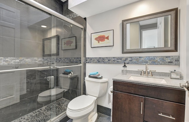 2530 NW 52nd St, Boca Raton, FL 33496 - full bath featuring toilet, vanity, tile walls, a shower stall, and wainscoting