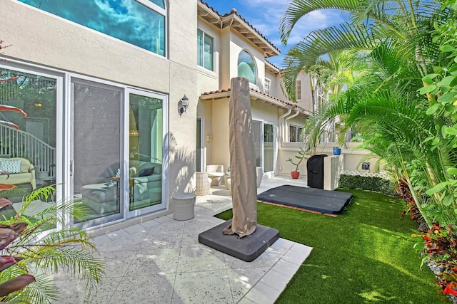 2530 NW 52nd St, Boca Raton, FL 33496 - back of property featuring stucco siding, a patio area, a tile roof, and a lawn