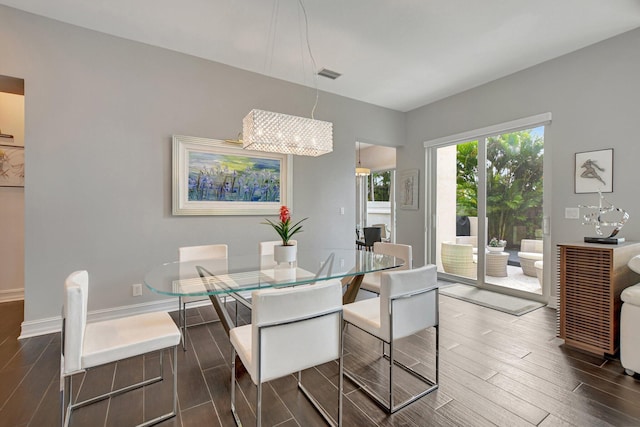 2530 NW 52nd St, Boca Raton, FL 33496 - dining space featuring dark wood-style floors, baseboards, and a chandelier