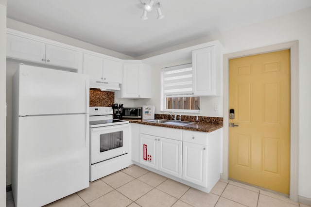 kitchen with white appliances, under cabinet range hood, a sink, white cabinets, and light tile patterned floors
