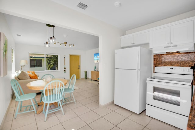 kitchen with white appliances, under cabinet range hood, white cabinetry, light tile patterned floors, and hanging light fixtures