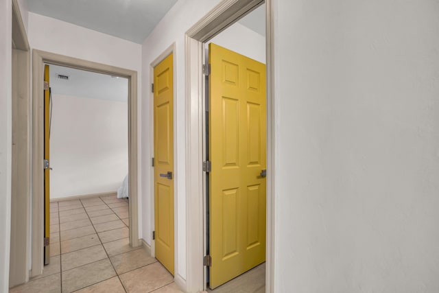 corridor featuring light tile patterned floors