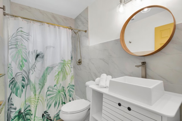 bathroom featuring tile walls, toilet, a shower with curtain, and vanity