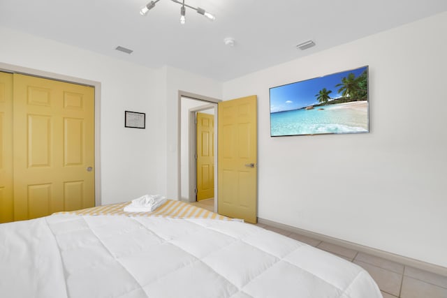 bedroom with light tile patterned floors and baseboards