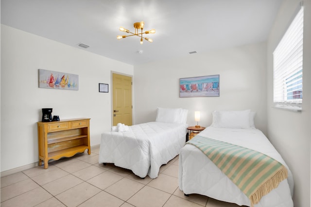bedroom with a chandelier and light tile patterned floors