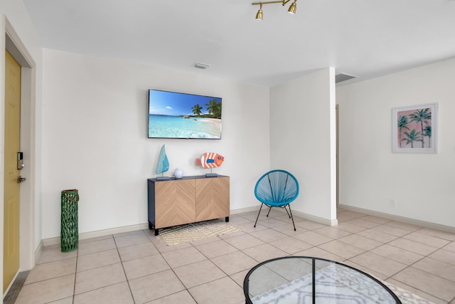 living area with light tile patterned floors and baseboards