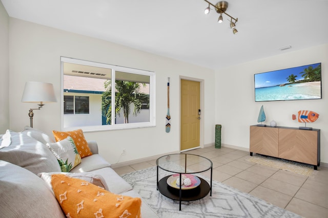 living area featuring tile patterned floors and baseboards