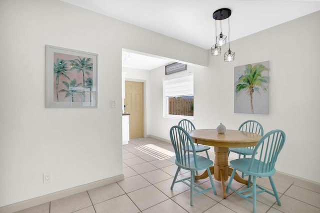 dining space with baseboards and light tile patterned floors