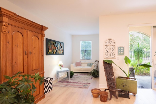 4891 Bonsai Cir Unit 105, Palm Beach Gardens, FL 33418 - sitting room with baseboards and wood finished floors
