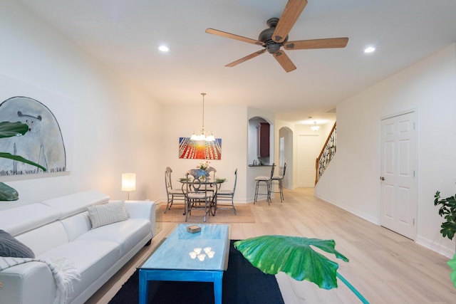 4891 Bonsai Cir Unit 105, Palm Beach Gardens, FL 33418 - living room with arched walkways, recessed lighting, wood finished floors, and stairway