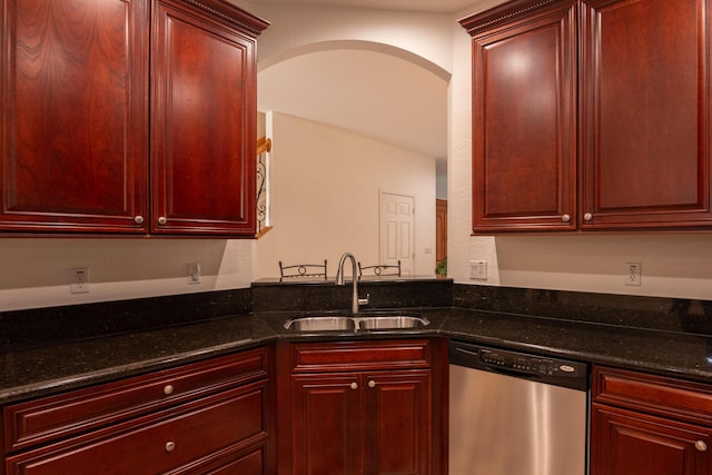 4891 Bonsai Cir Unit 105, Palm Beach Gardens, FL 33418 - kitchen featuring a sink, arched walkways, dark stone countertops, reddish brown cabinets, and stainless steel dishwasher