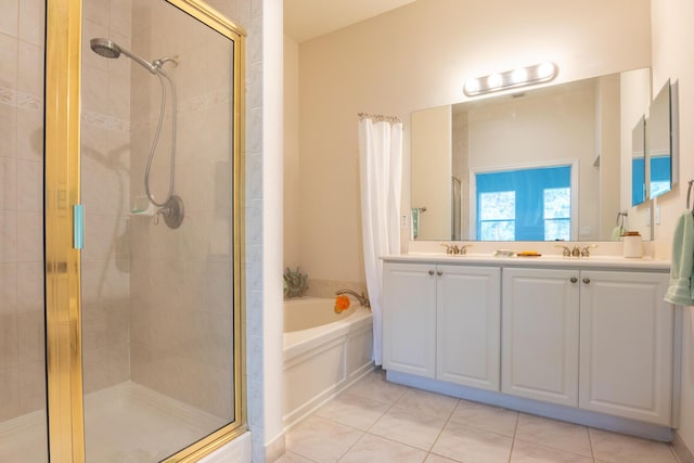 4891 Bonsai Cir Unit 105, Palm Beach Gardens, FL 33418 - full bathroom with a sink, double vanity, tile patterned floors, a shower stall, and a garden tub
