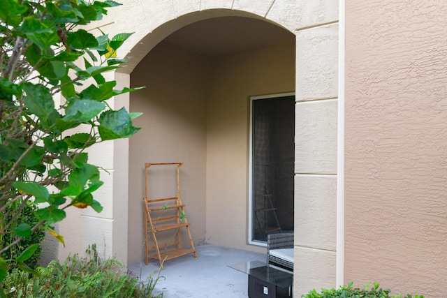 4891 Bonsai Cir Unit 105, Palm Beach Gardens, FL 33418 - view of exterior entry featuring stucco siding