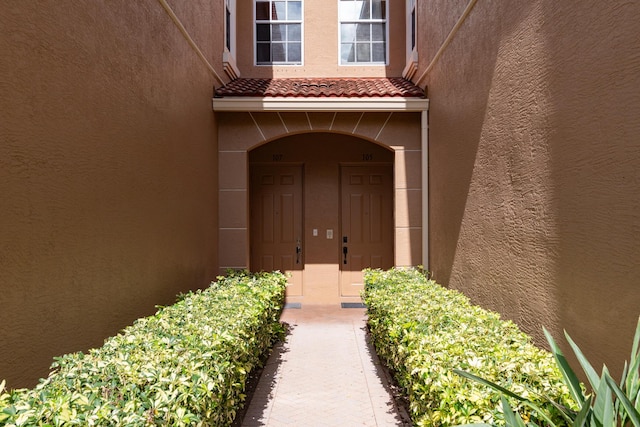 4891 Bonsai Cir Unit 105, Palm Beach Gardens, FL 33418 - property entrance featuring stucco siding and a tile roof