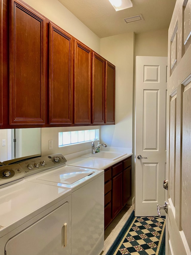 3531 Plume Way SE, Palm Bay, FL 32909 - laundry area featuring visible vents, washing machine and clothes dryer, cabinet space, a sink, and light tile patterned flooring