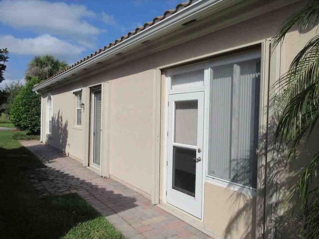 3531 Plume Way SE, Palm Bay, FL 32909 - view of property exterior with a patio, a tile roof, and stucco siding